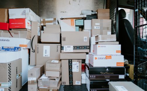 A large pile of parcels inside the back of a delivery truck