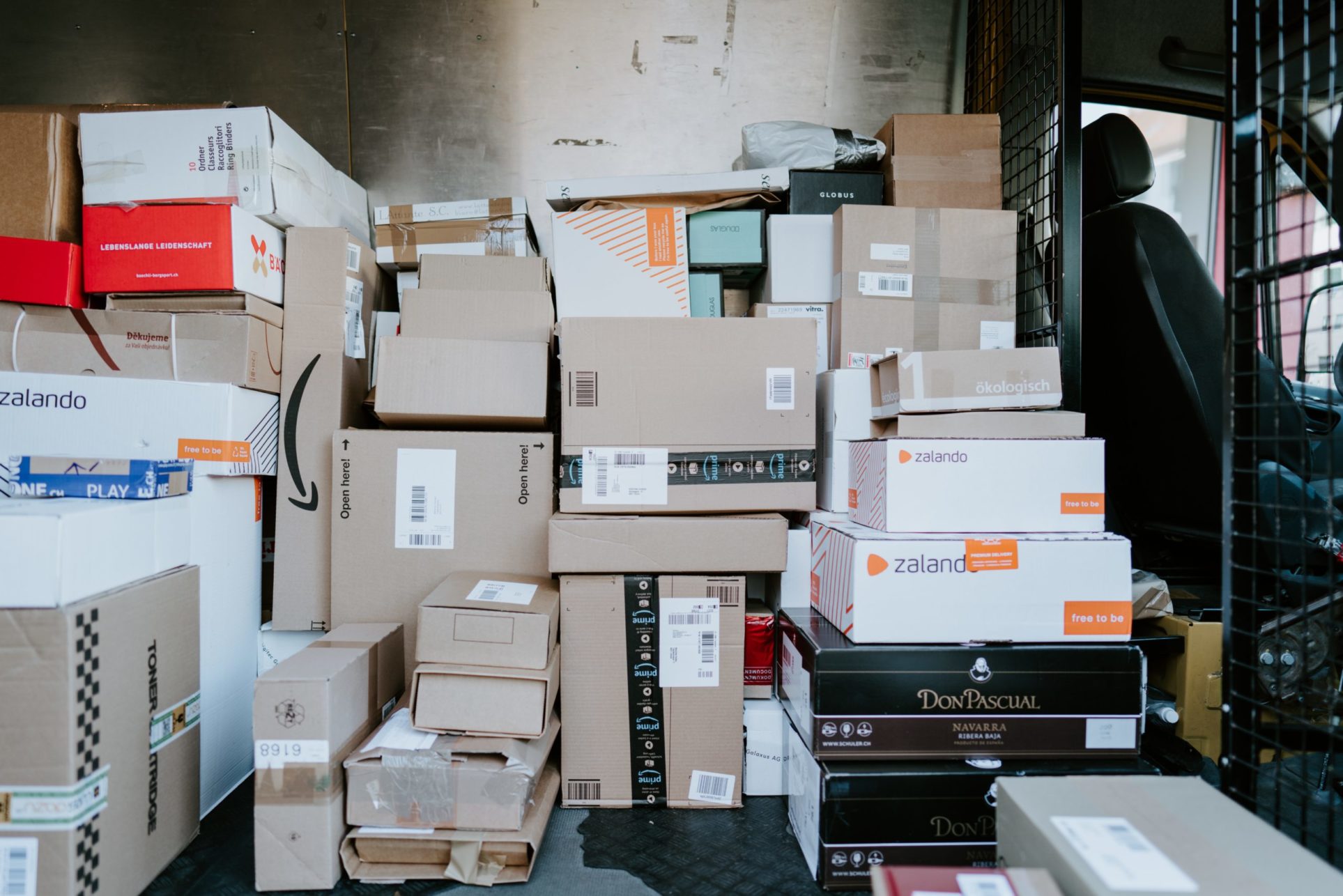 A large pile of parcels inside the back of a delivery truck